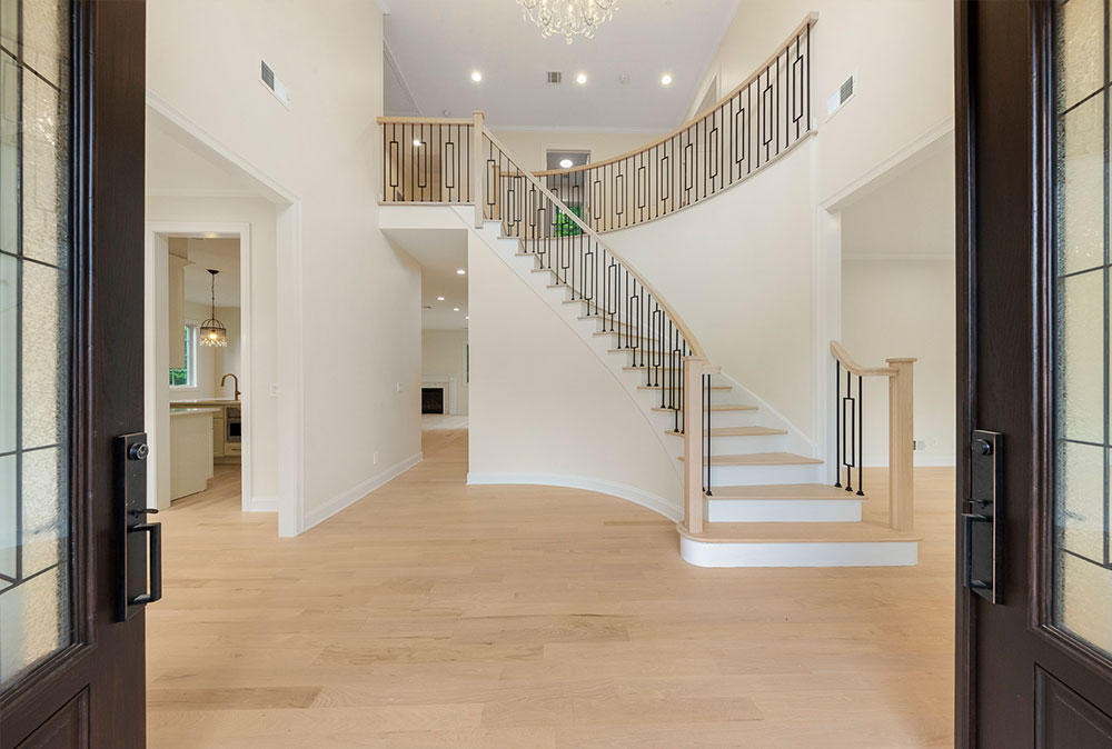 Wood floor with spiral staircase leading to a second floor