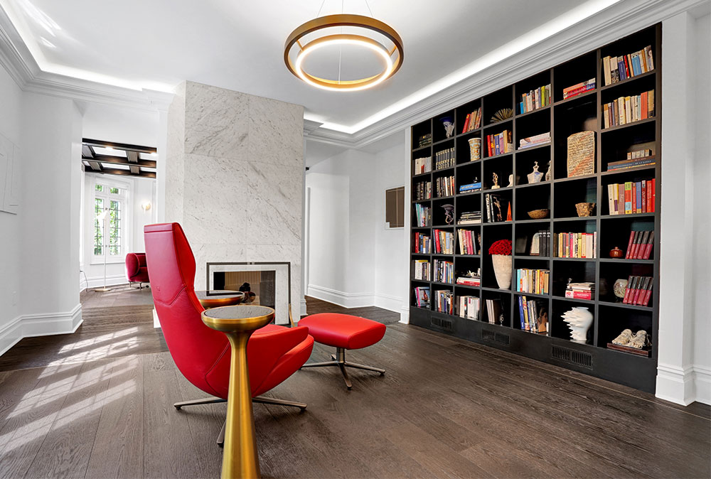 Luxury library with red reclining chair and chandelier