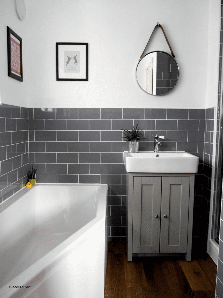 Bathtub and sink against black square tiled wall