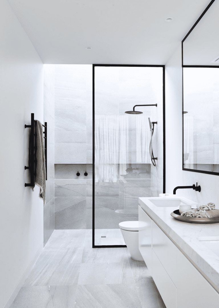 white marble bathroom with half glass wall
