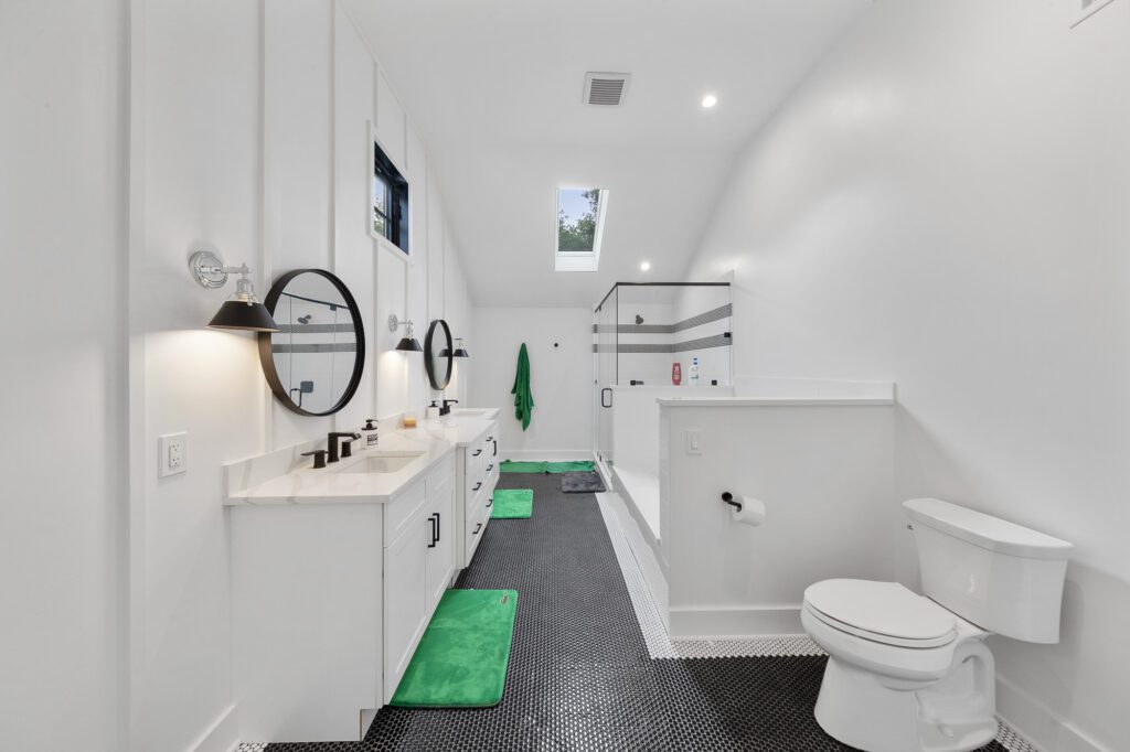 Dual-bathroom mirrors and sink spaces in a custom white bathroom