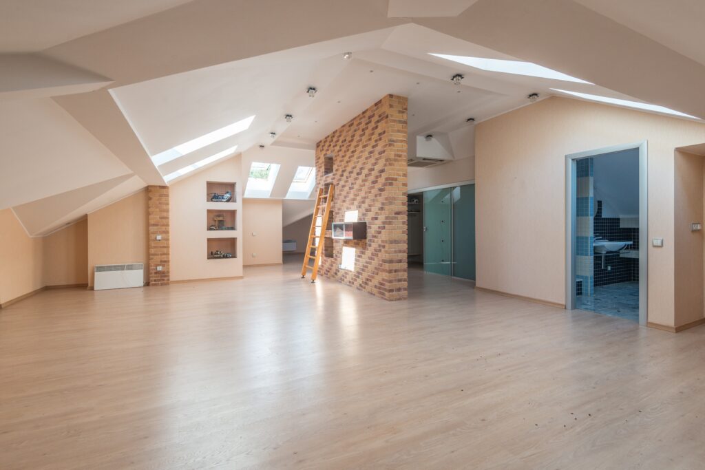 An open attic floor space with bumped out shelving