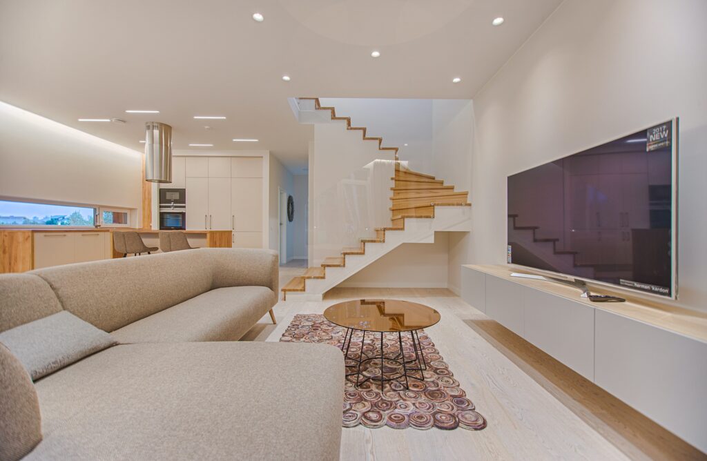 Sleek custom home with staircase and flatscreen TV