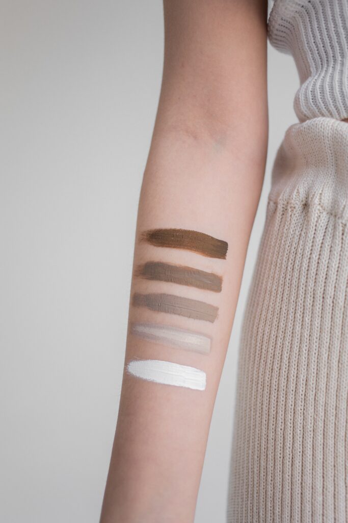 Person with 5 horizontal lines of various color schemes painted on their arm