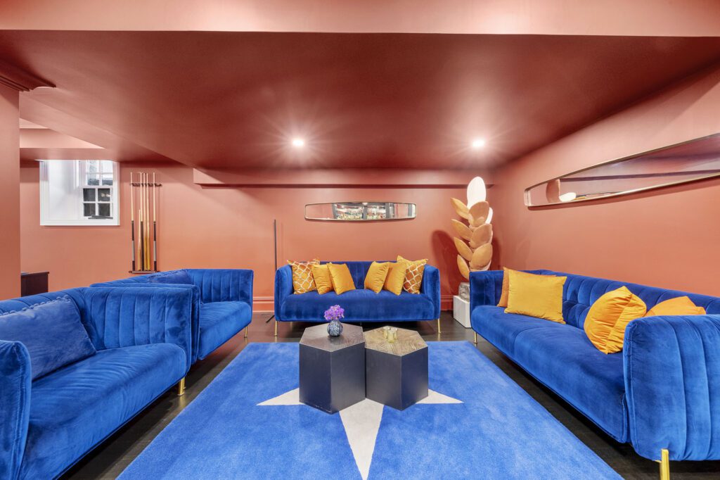 Lounge space with blue and red colored carpets and walls
