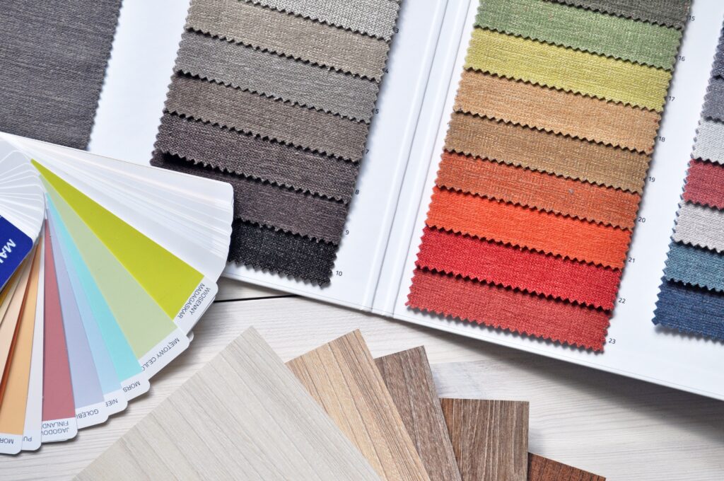 Swatches of various color schemes and tile options fanned out on a table