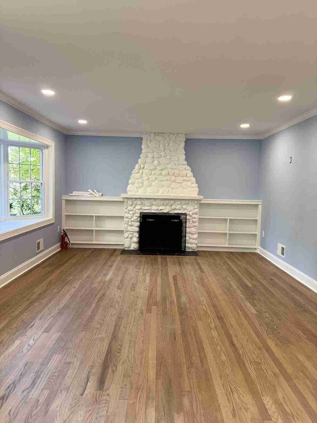 Exterior curb appeal upgrade featuring new siding stone accent wall, refreshed landscaping and modern garage door design