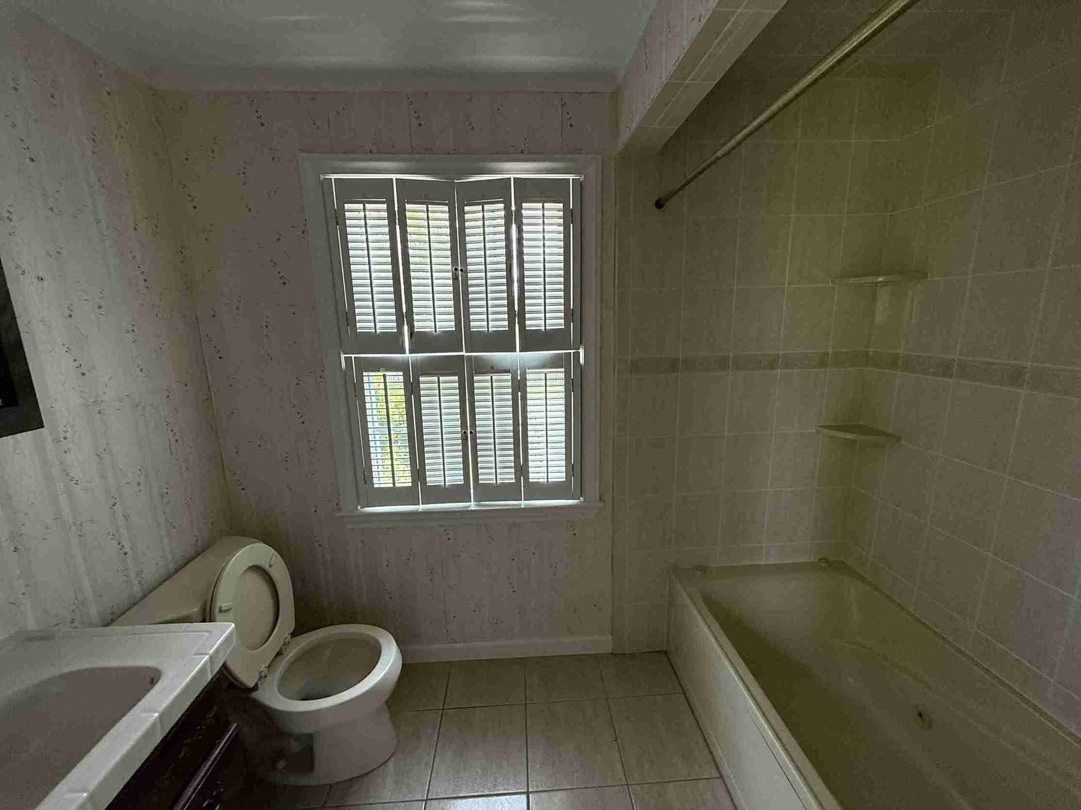 Completed exterior home renovation with fresh siding, updated windows, landscaped front yard and elegant garage door