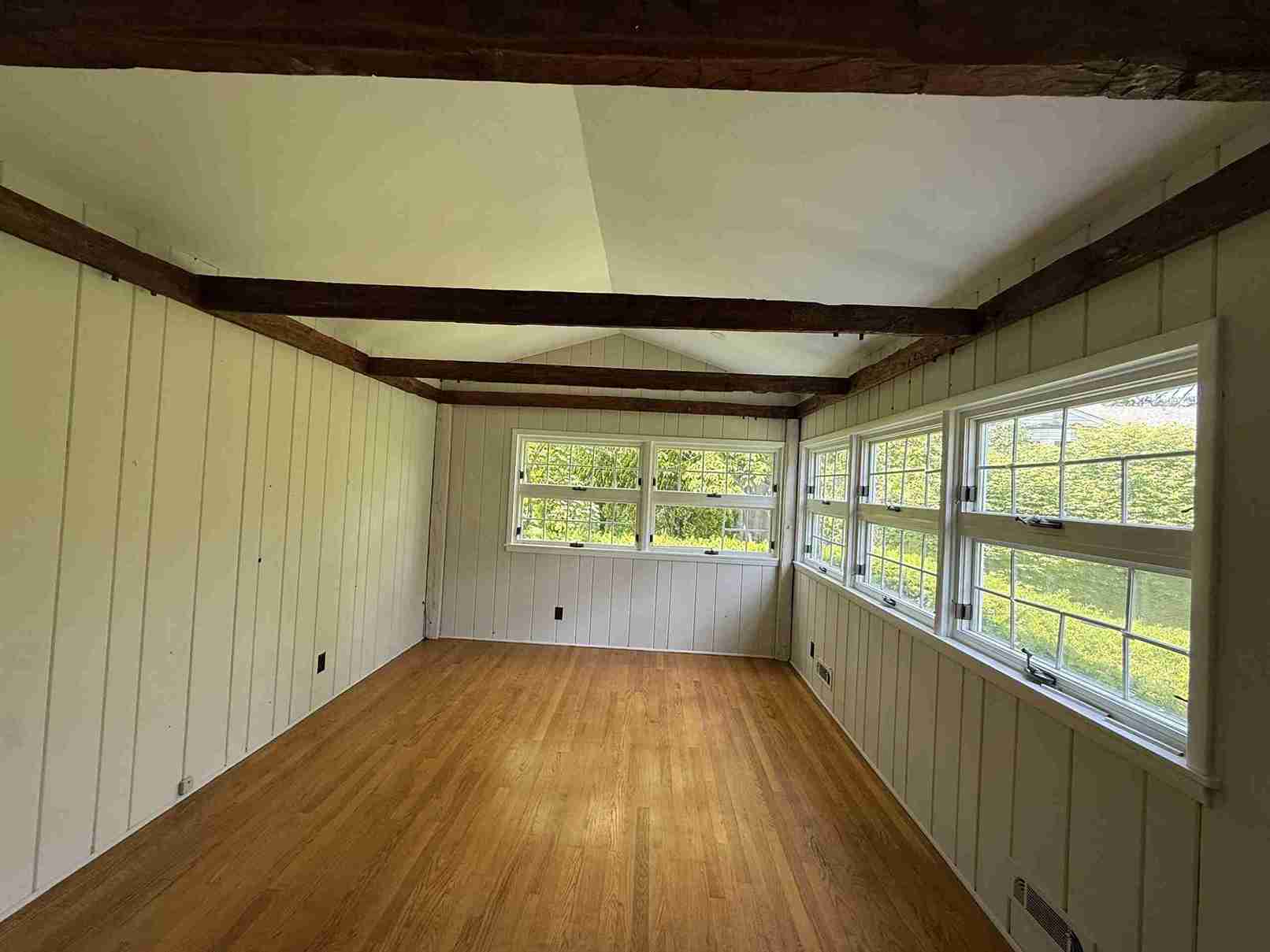 Contemporary bathroom remodel with freestanding bathtub, marble wall tile, glass shower enclosure and chrome fixtures.