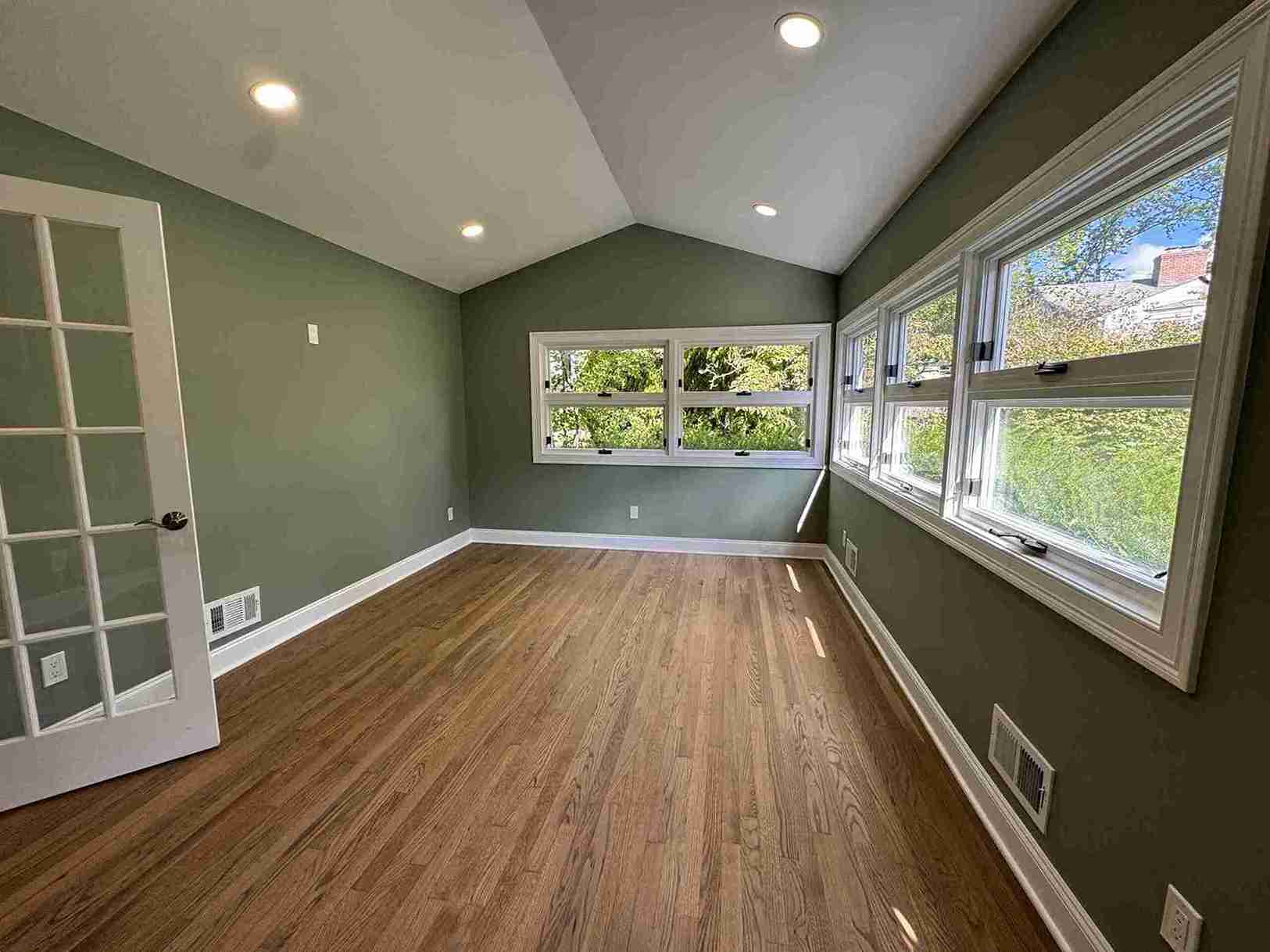 Sleek modern kitchen makeover showcasing floating shelves, stainless appliances, large island and under-cabinet lighting for stylish functionality