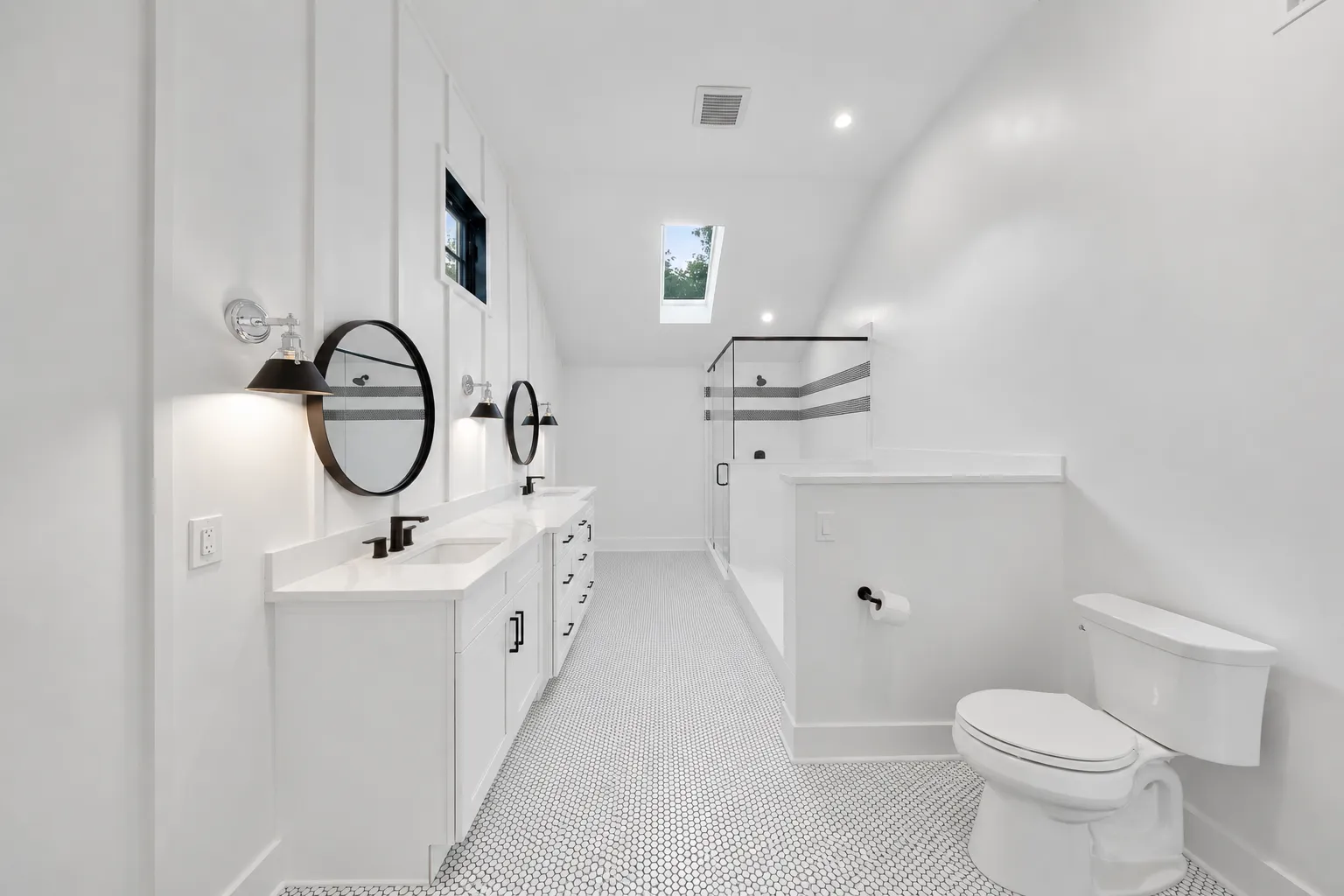 Dual-bathroom mirrors and sink spaces in a custom white bathroom