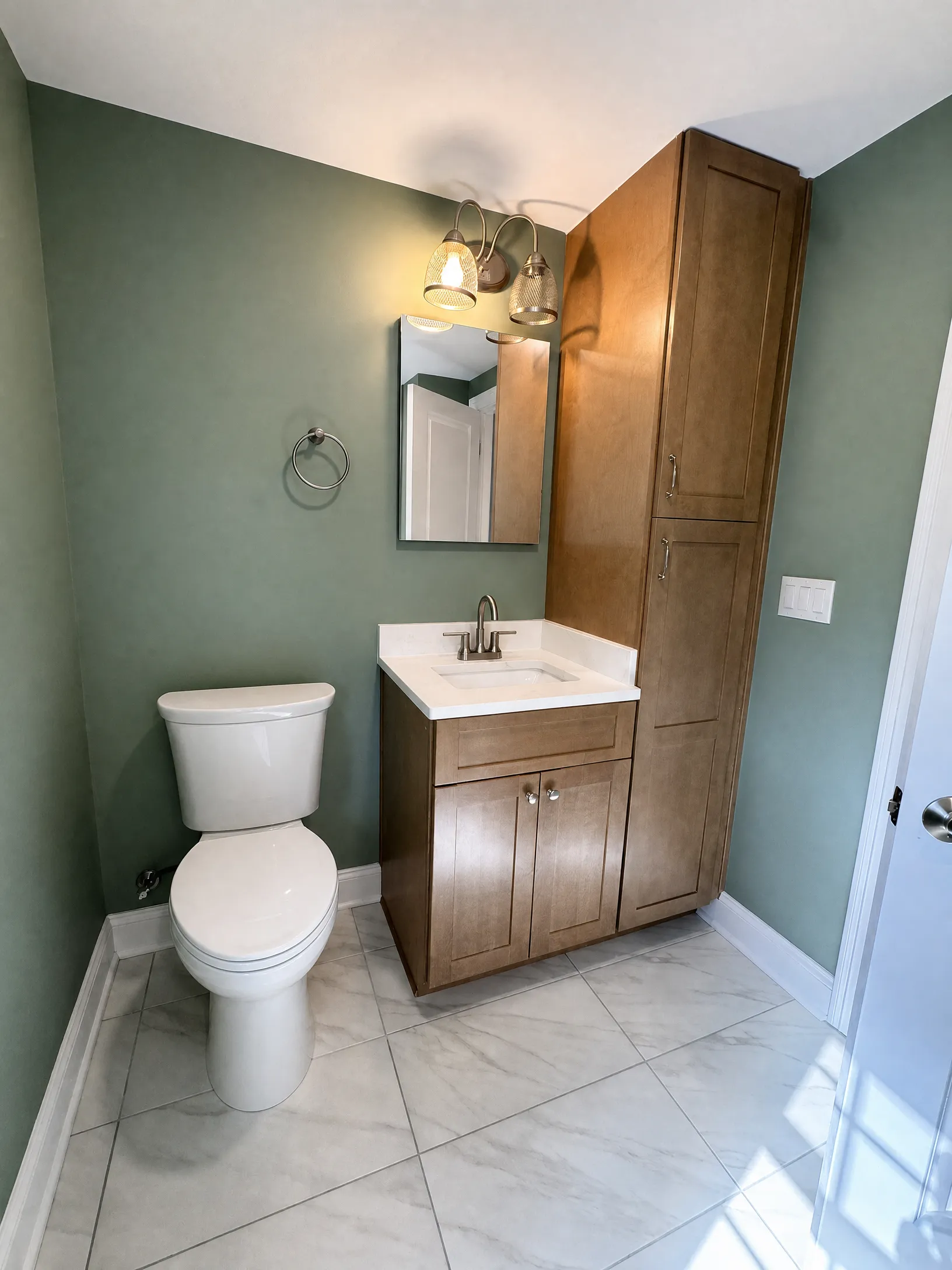 Finished bathroom with toilet and vanity