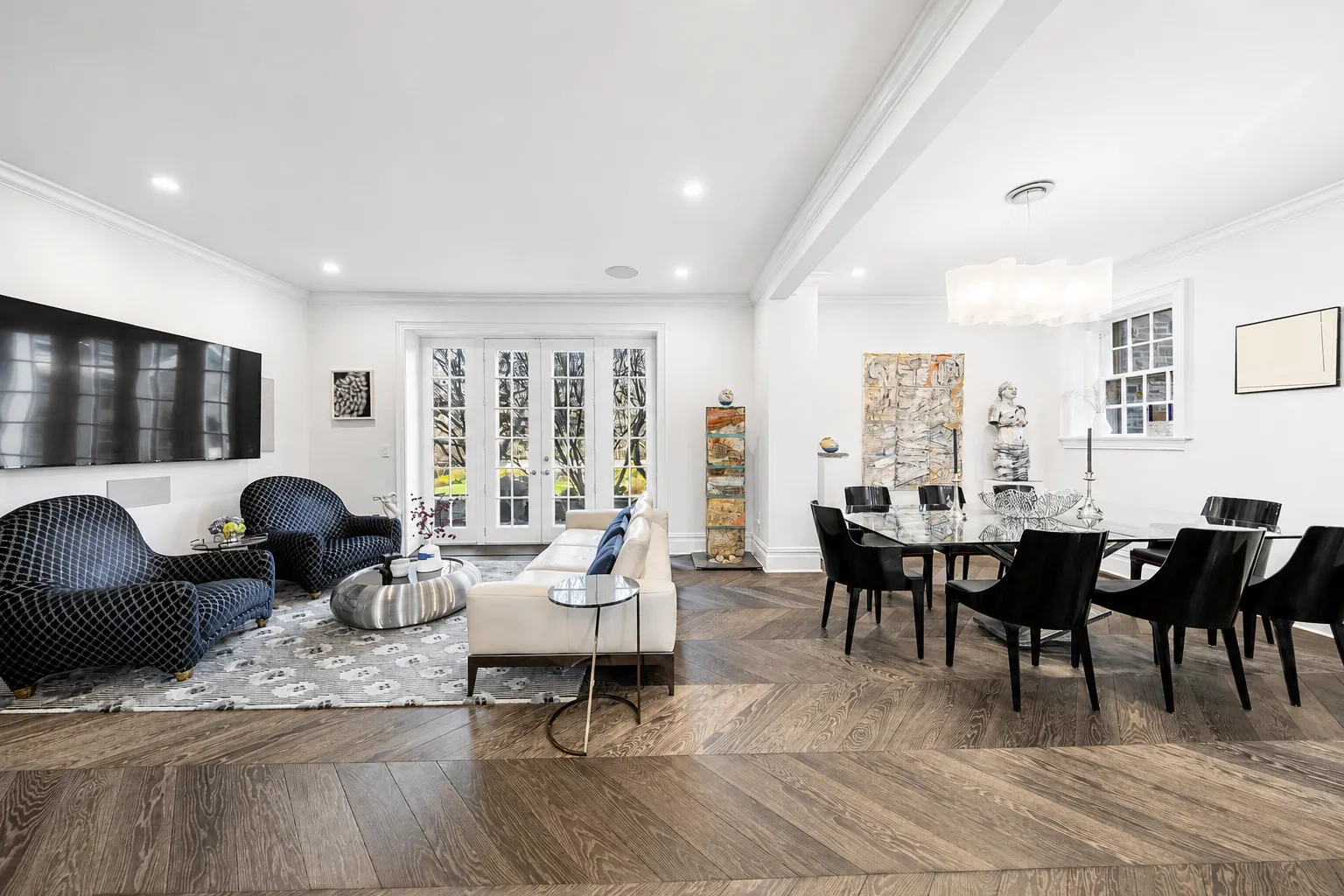 Modern open living and dining room with elegant decor and large windows